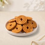 Wheat Chakri – crunchy spiral wheat chakri on a plate, Radhe Prem Ni Mithaas